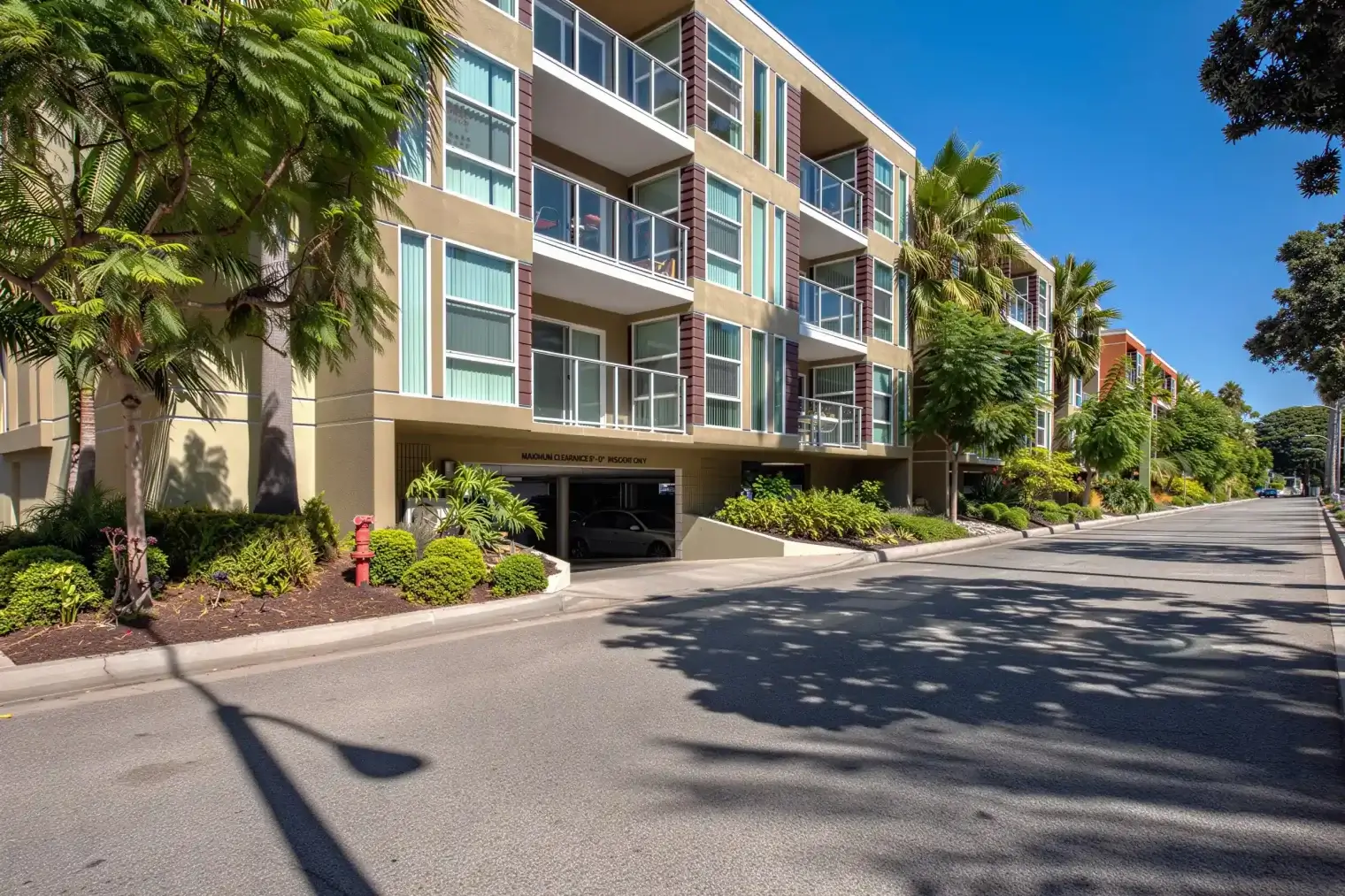 Harborside Marina Bay apartment exterior with private balconies and tropical landscaping in Marina del Rey