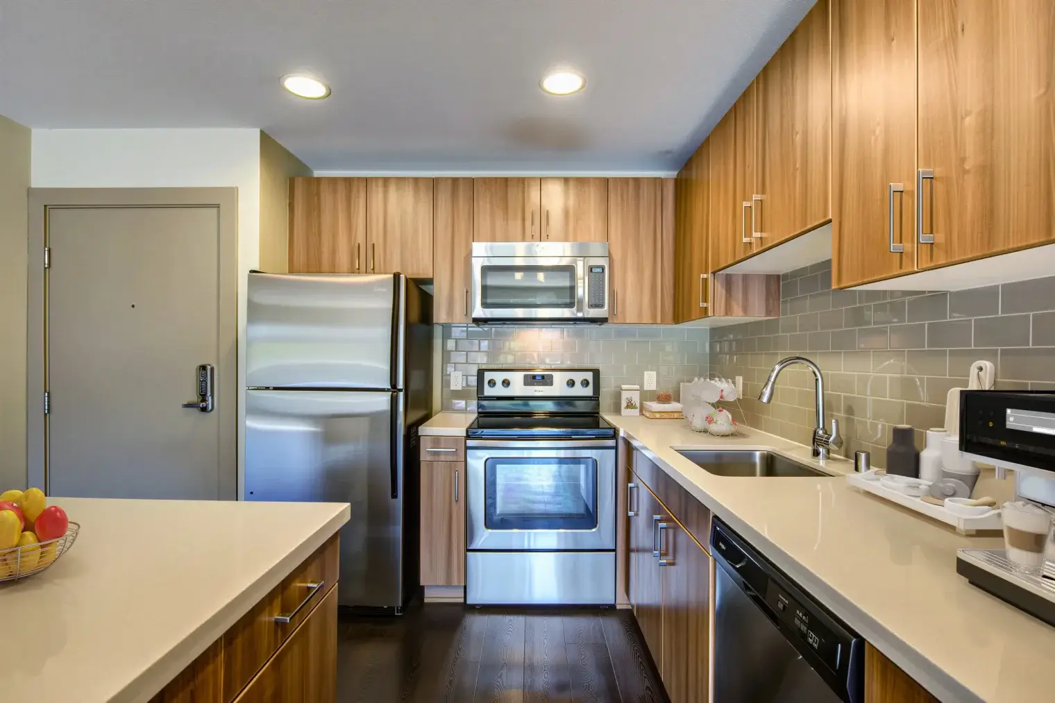 Contemporary Marina del Rey apartment kitchen with stainless steel appliances and tile backsplash