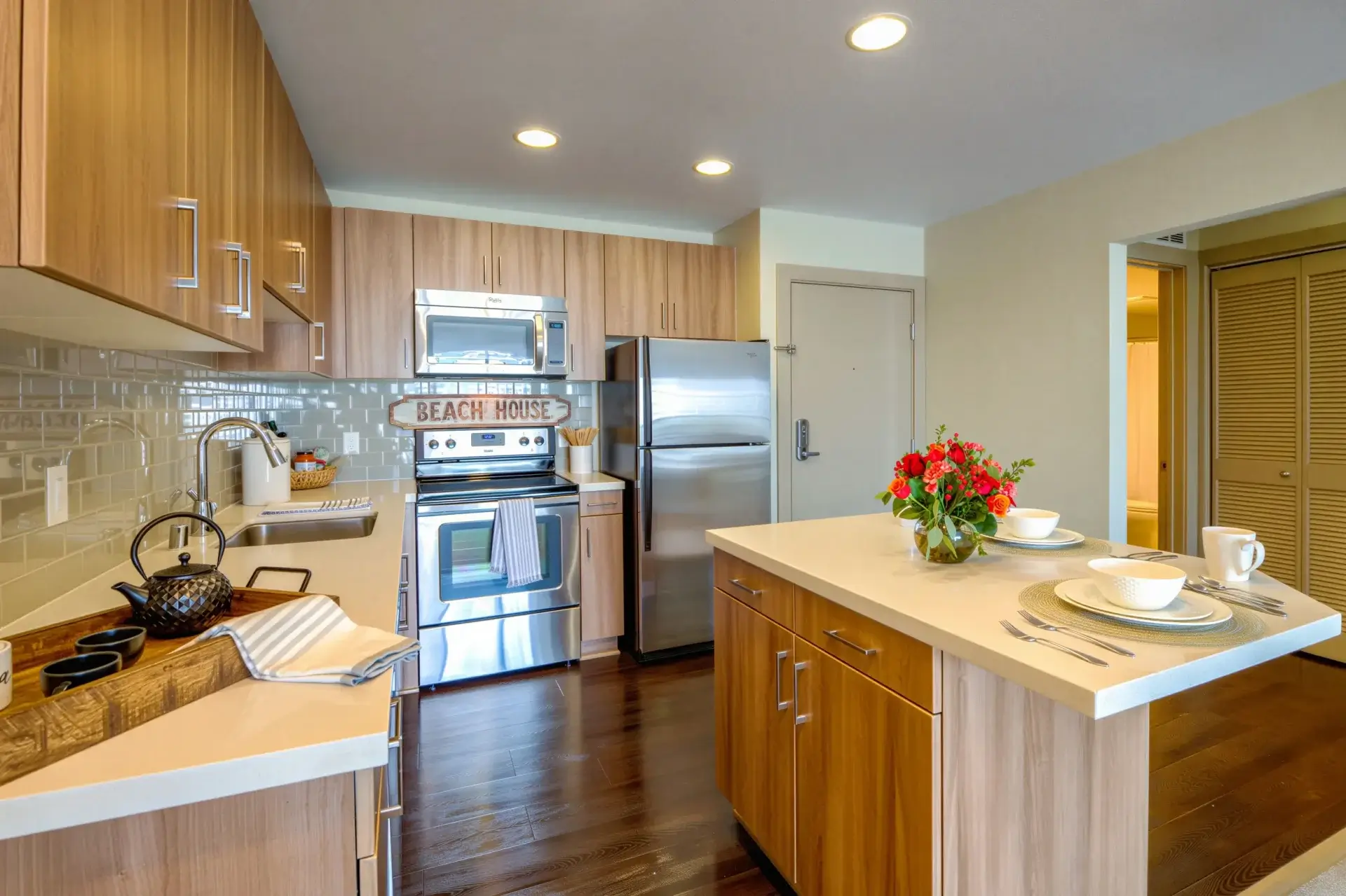 Modern apartment kitchen with island and stainless steel appliances at Harborside Marina Bay